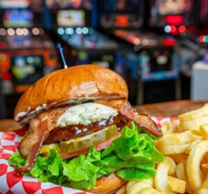 Burger and fries with bar in the background