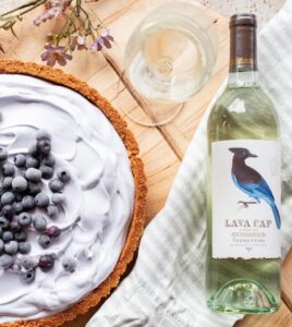 Glass of wine with a wine bottle and blueberry pie