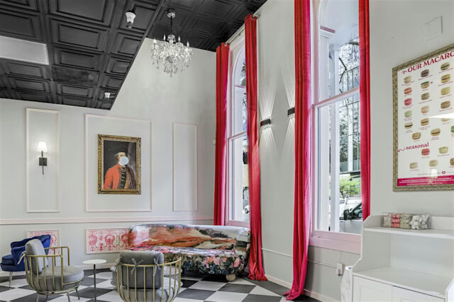 View inside of Le Macaron Sacramento - long red curtains, nice seating and checkered floors